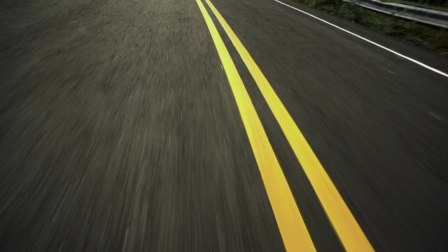 Front pov view of fast car driving on asphalt road