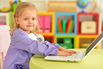 Portrait of cute girl using laptop at home