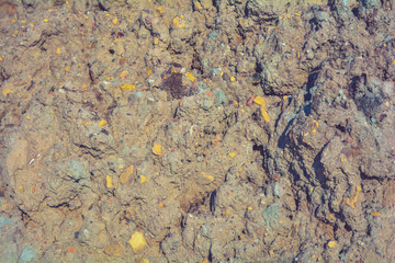 Loose rough dry clay mud with pebbles. Natural texture of dry brown dirty soil