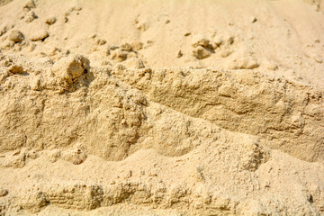 Pile of yellow sand texture. Construction Supplies. Sand pile with small stones