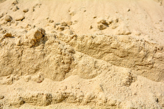 Pile of yellow sand texture. Construction Supplies. Sand pile with small stones