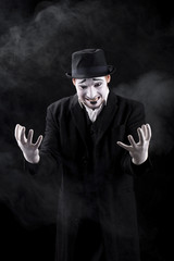mime shows theatrical emotions on black background