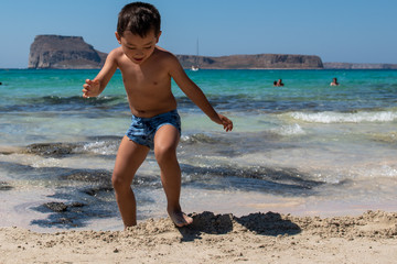 Fototapeta na wymiar Cute boy in a very beautiful beach