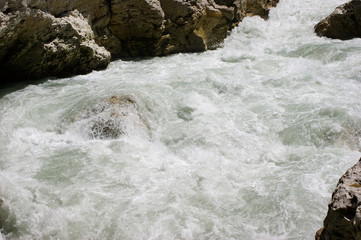 Fast mountain river. Rapids. Bubbling water. Canyon of the Belaya River. Rocks.