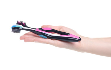 Toothbrushes in hand health care, family on white background isolation