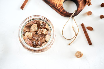 Brown cane sugar lump in a sugar bowl, top view. Concept diet, junk food, health.