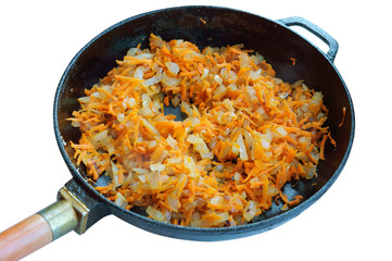 Roasted carrots with onions. Sliced onions and carrots in a frying pan.