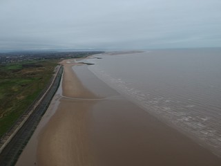 aerial view of long sandy beach in fall