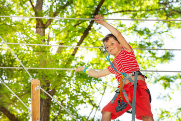 Portrait of a boy at rope climbing adventure park