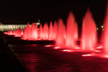 Fountains backlighted by red in Moscow in victory park, Russia
