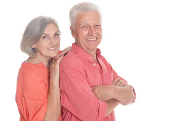 Smiling senior couple wearing bright clothing on white background