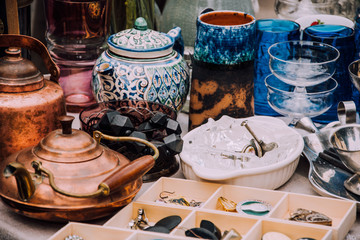 flea market. Vintage stuff. Aesthetics. Fair of old things. Sale of unnecessary things. Garage sale. Weekend Market. Dishes, souvenirs, teapot, cups, spoons, figurines. Antiques. Second hand - obrazy, fototapety, plakaty