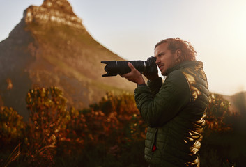 Professional nature wildlife photographer take photos on camera - Powered by Adobe