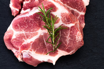 Raw meat,  steak with spices on black background