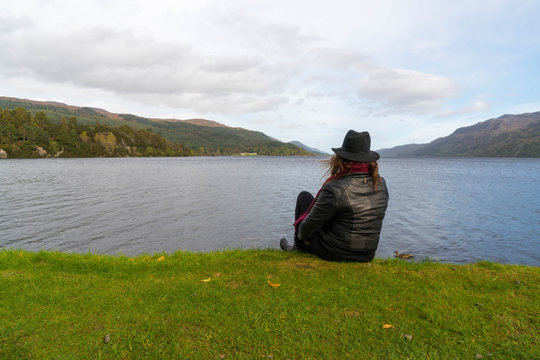 Woman view Scotland's Loch Laggan 