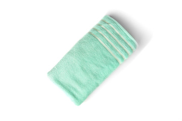 Green towel isolated on white background.