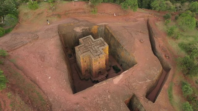 Rotating bird's eye perspective of beautiful Saint George rock-hewn monolithic church in Lalibela, landmark travel destination and important religious site in Ethiopia