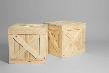 Pair of wooden crates on grey background