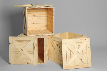 Group of wooden crates on grey background