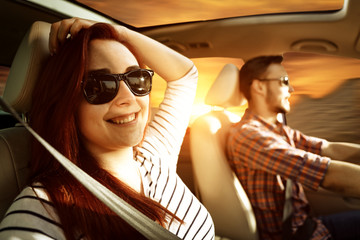 Young two people in car and autumn trip. Free space for your decoration and sunset time. 