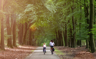 Little girl cycling with her mother in Holland