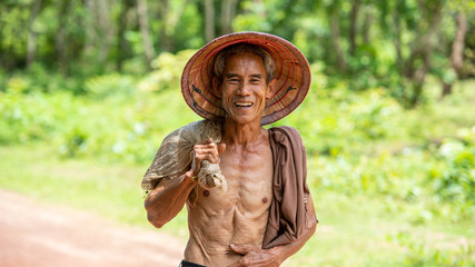 Portrait of happy farmer in rice field at countryside Thailand.