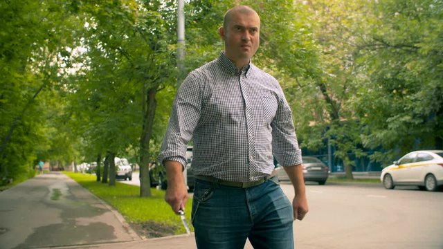 Criminal threatening with a knife on the street. Criminal concept