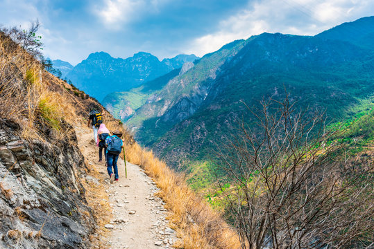 Hiking trail in Tiger Leaping Gorge. Travelers hiking in the mountains. Located 60 kilometres north of Lijiang, Yunnan, China.