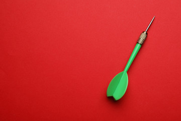 Green dart arrow on red background, top view with space for text