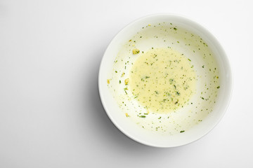 Dirty bowl with food leftovers on white background, top view