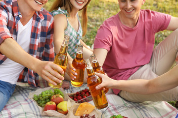 Young people enjoying picnic in park on summer day, closeup
