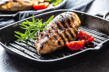 Chicken breast grilled with spices peper salt tomatoes and rosemary