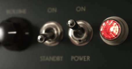 Guitarist Powering On Vintage Tube Guitar Amplifier. Music Related 4K Concept