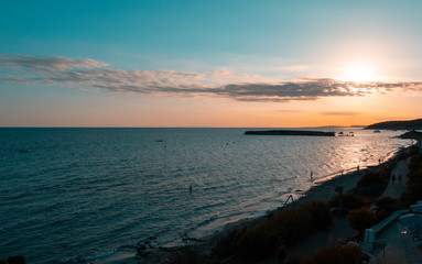 Beach of Sant Tomas on the island of Menorca during sunset. Mediterranean sea in spanish island.