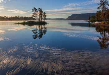 Fototapeta premium Foggy morning at the scenic Lake Saggat near to Arrenjarka in Swedish Lapland, Norrbotten County