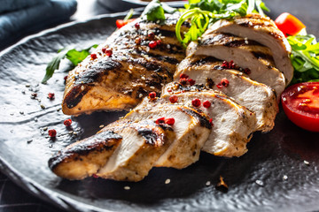 Chicken breast grilled with spices peper salt tomatoes and arugula