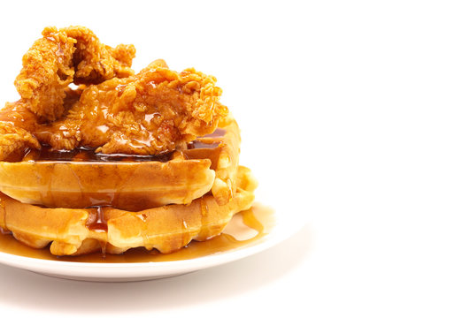 Pile Of Chicken And Waffles Isolated On A White Background