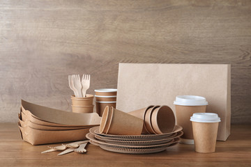 New paper dishware on wooden table. Eco life