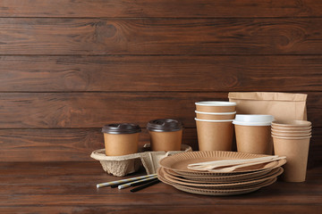 New paper dishware on dark wooden table, space for text. Eco life