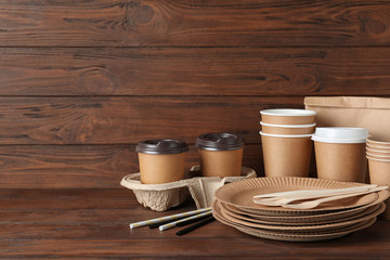 New paper dishware on dark wooden table, space for text. Eco life