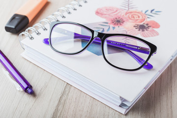 Woman glasses with planner and pencils