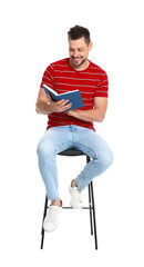 Handsome man reading book on white background