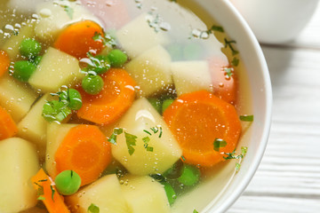 Bowl of fresh homemade vegetable soup on table, closeup