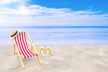 Summer Vacation and Holiday Trip Concept : Beach chair, weave hat and white sandal flip flop on...