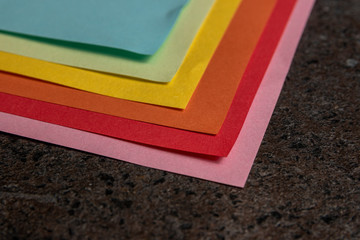 Top view of colorful sticky note papers on dark table.