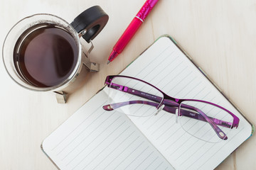 Woman glasses with notebook, coffee and pencil