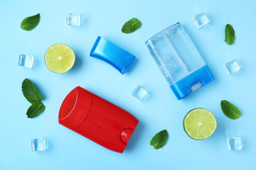 Flat lay composition with natural male deodorants on light blue background