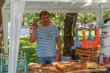A funny carpenter with his products. FORMA MARKET - a city festival for the promotion of handmade...