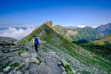 Hiker reaching a pass in the Ecrins National Park, french Alps