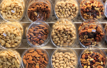 Different types of nuts in wooden displays in the Boqueria market.Concept food